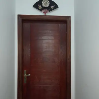 a wooden door with a clock on top of it at الغردقة الانتر in Hurghada