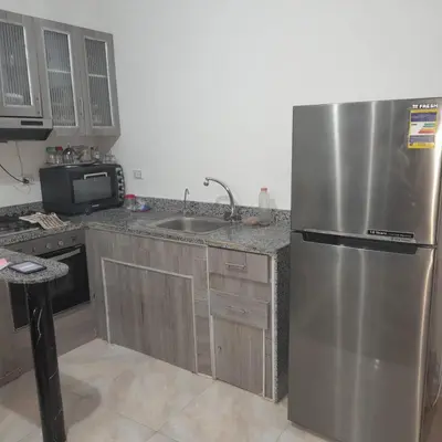 a kitchen with a stainless steel refrigerator and a sink at الغردقة الانتر in Hurghada
