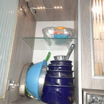 a refrigerator filled with dishes and a blue pot at الغردقة الانتر in Hurghada