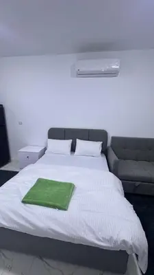 a bed with a green towel on top of it at Central Hurghada Studios in Hurghada