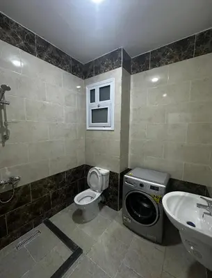 a bathroom with a washing machine and a sink at Central Hurghada Studios in Hurghada