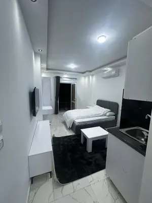 a small room with a bed and a sink at Central Hurghada Studios in Hurghada