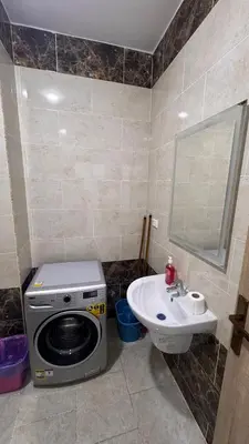 a bathroom with a washing machine and a sink at Central Hurghada Studios in Hurghada