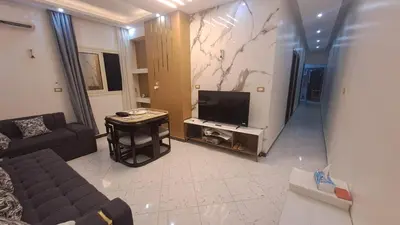 a living room with a couch and a flat screen tv at الغردقه الكوثر in Hurghada