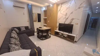 a living room with a couch and a flat screen tv at الغردقه الكوثر in Hurghada