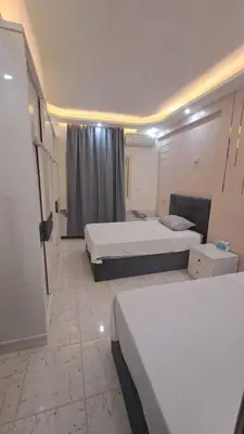 a hotel room with two beds and a window at الغردقه الكوثر in Hurghada