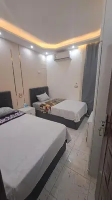 a hotel room with two beds and a room with two at الغردقه الكوثر in Hurghada
