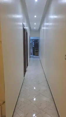 an empty hallway with a tile floor in a building at الغردقه الكوثر in Hurghada