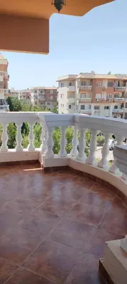 a balcony with a white railing and some buildings at Hurghada cozy apartment in Hurghada