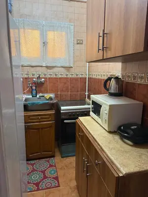 a kitchen with a microwave and a sink at Hurghada cozy apartment in Hurghada