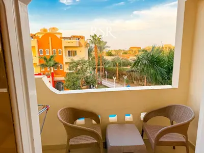 a room with a view of a city from a window at Apartment with a private roof top , pool , Garden in Hurghada