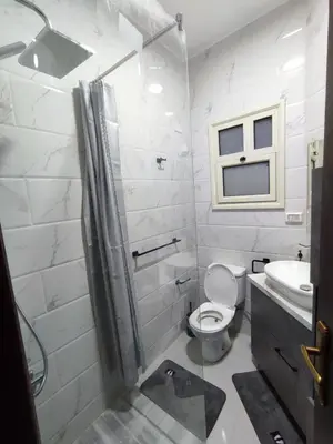a white bathroom with a toilet and a sink at Perfect studio for holiday in Hurghada