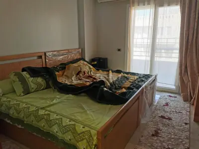 a bed with a blanket on it in a bedroom at Apartment in Hurghada , Ahyaa, , in front of Royal beach in Hurghada