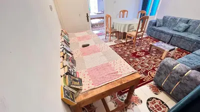 a living room with a table and a couch at Family Flat With Breakfast in Luxor