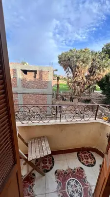 a balcony with a bench on top of a building at Family Flat With Breakfast in Luxor