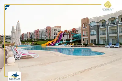 a swimming pool in a resort with a water slide at Oyster bay resort studio in Marsa Alam