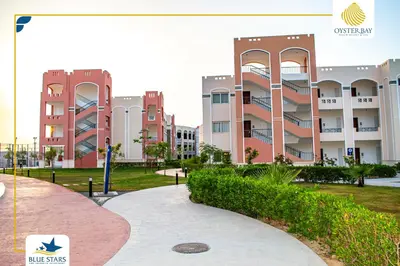 a view of a campus with buildings in the background at Oyster bay resort studio in Marsa Alam