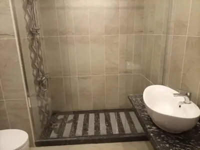 a bathroom with a sink and a toilet at Oyster bay resort studio in Marsa Alam