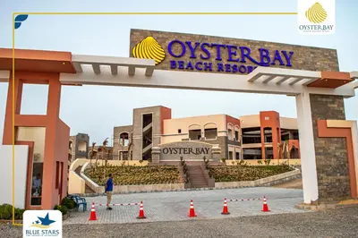 a sign for the osterley bay beach resort at Oyster bay resort studio in Marsa Alam