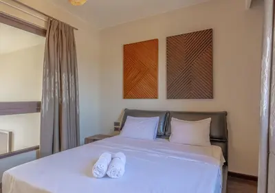 a bedroom with a bed with two white towels on it at Prime 4BR Villa in Ancient Sands, El Gouna Private Swimming Pool & Lagoon Access in Hurghada