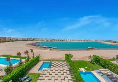 an aerial view of a beach with two swimming pools at Prime 4BR Villa in Ancient Sands, El Gouna Private Swimming Pool & Lagoon Access in Hurghada