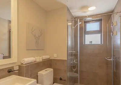 a bathroom with a shower and a toilet and a sink at Prime 4BR Villa in Ancient Sands, El Gouna Private Swimming Pool & Lagoon Access in Hurghada