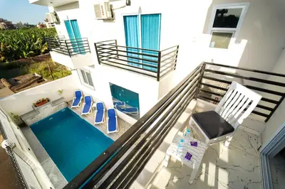a house with a swimming pool on a balcony at Villa Pure Luxor in Luxor