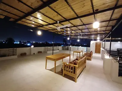 a room with a table and chairs on a roof at Villa Pure Luxor in Luxor