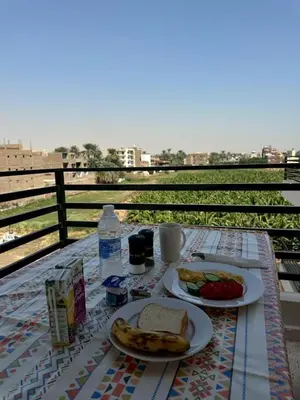 a table with two plates of food on top at Villa Pure Luxor in Luxor