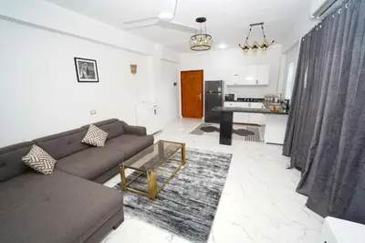 a living room with a couch and a kitchen at Villa Pure Luxor in Luxor