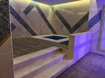 a bathroom with a shower with purple lighting at The view -Clubhouse in Hurghada