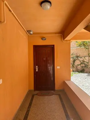 an orange wall with a door in a hallway at The view -Clubhouse in Hurghada