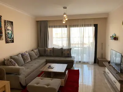 a living room with a couch and a coffee table at The Clubhouse Apartment in Hurghada
