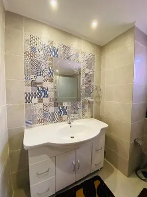 a bathroom with a sink and a mirror on the wall at The Clubhouse Apartment in Hurghada
