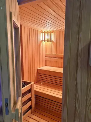 a wooden sauna with a bench in the middle at The Clubhouse Apartment in Hurghada