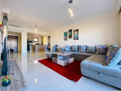 a living room with a couch and a table at The Clubhouse Apartment in Hurghada