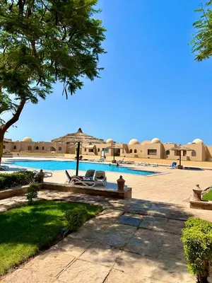 a resort with a swimming pool and a building at The view -Nubian One bedroom in Hurghada