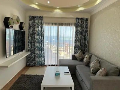 a living room with a couch and a table and a window at The view -Nubian One bedroom in Hurghada