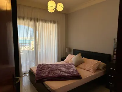 a bedroom with a bed with a large window at The Nubian Sea View in Hurghada