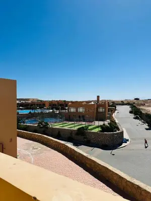 a view of the pool from the balcony of a building at The Nubian Sea View in Hurghada
