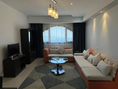 a living room with two couches and a tv at The Nubian Sea View in Hurghada