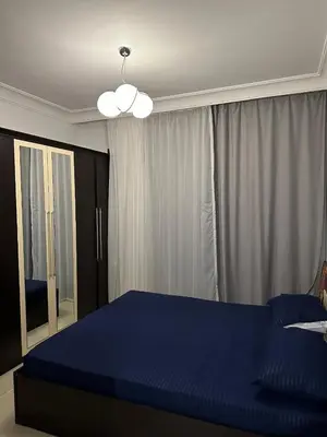 a bedroom with a large blue bed and a mirror at The Nubian Seabreeze in Hurghada