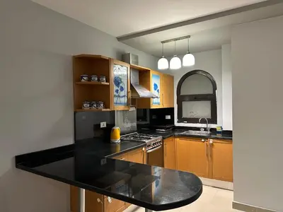 a kitchen with a black counter top and a sink at The Nubian Seabreeze in Hurghada