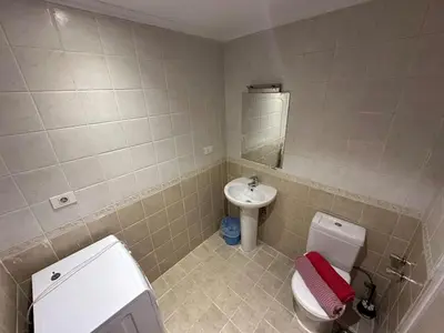 a bathroom with a toilet and a sink at The Nubian Seabreeze in Hurghada