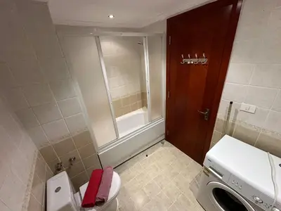 a small bathroom with a toilet and a window at The Nubian Seabreeze in Hurghada