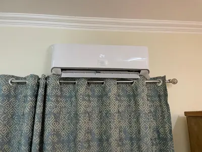a curtain rod with a air conditioner above a window at Luxe Nest Luxor Serviced Apartments 102 in Luxor