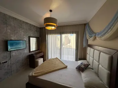 a bedroom with a bed and a large window at The Nubian Two-Bedroom Apartment in Hurghada