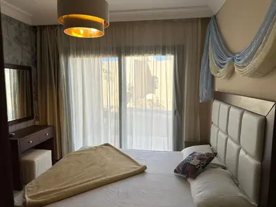 a bedroom with a bed with a large window at The Nubian Two-Bedroom Apartment in Hurghada