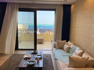 a living room with a couch and a view of the ocean at The Hill House in Hurghada