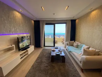 a living room with a couch and a tv at The Hill House in Hurghada